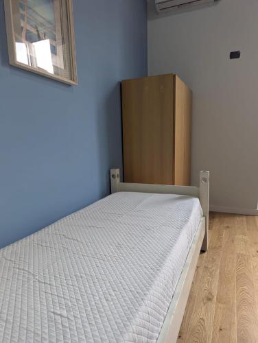 a bedroom with a bed and a wooden cabinet at Stella Maria in Santa Maria Capua Vetere