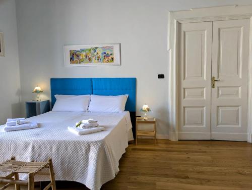 a bedroom with a blue bed with towels on it at Stella Maria in Santa Maria Capua Vetere