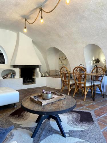 un salon avec une table et une cheminée dans l'établissement Pleasant Lower Villa Breil sur Roya, à Breil-sur-Roya