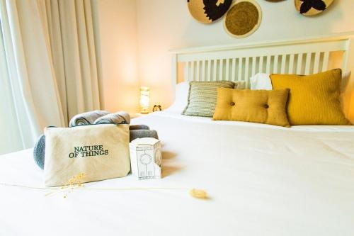 a bedroom with a bed with a bag on it at Voyage Studio In Mayan in Abu Dhabi