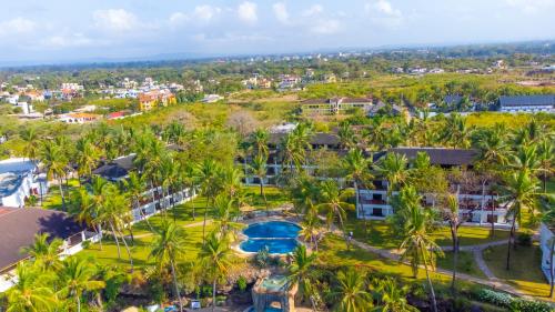an aerial view of a resort with a pool and palm trees at PrideInn Flamingo Beach Resort & Spa Mombasa in Mombasa