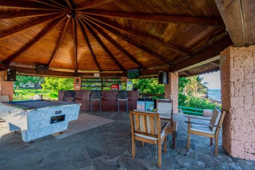 a patio with a pool table and a bar at PrideInn Flamingo Beach Resort & Spa Mombasa in Mombasa