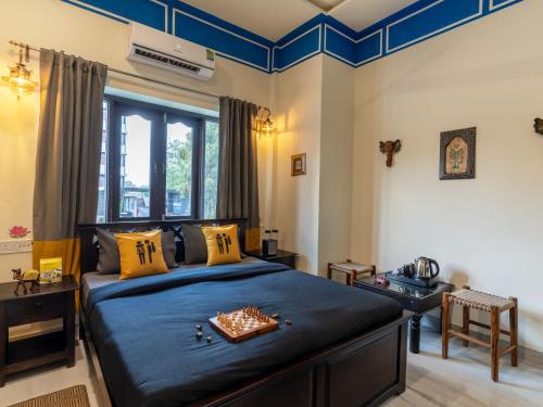 a bedroom with a bed with a chess board on it at The Hosteller Jodhpur in Jodhpur