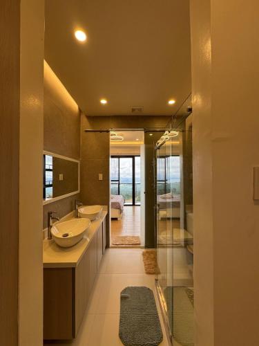 a bathroom with two sinks and a large mirror at The Hillside Villa Tagaytay in Laurel