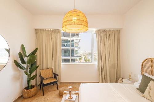 a bedroom with a white bed and a window at Voyage One Bedroom In Mayan in Abu Dhabi