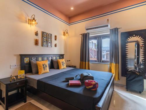 a bedroom with a blue bed and a window at The Hosteller Jodhpur in Jodhpur