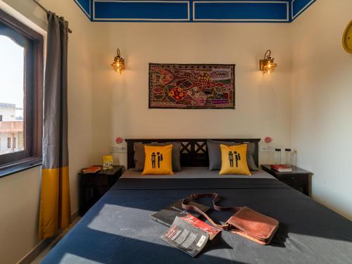 a bedroom with a bed with a bow tie on it at The Hosteller Jodhpur in Jodhpur