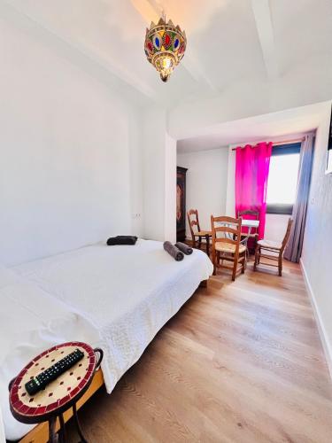 a bedroom with a bed and a dining room at El Beaterio Apartments in Tarifa