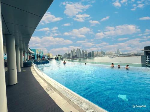 a swimming pool on the roof of a building at Dubai Palm Jumeirah - Free Infiniti Pool and Private Beach in Dubai