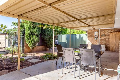 a pergola with chairs and a table under it at Cosy Corner Retreat by SwanBnB Management in Hamilton Hill