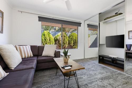 a living room with a couch and a table at Cosy Corner Retreat by SwanBnB Management in Hamilton Hill