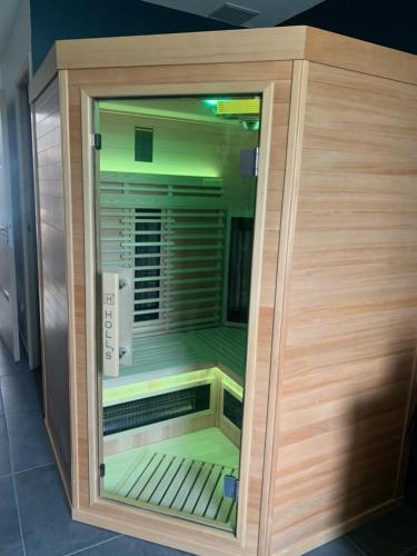 a wooden enclosure with a cooler in a room at MAISON D' HÔTES L'Écurie de Luzerand in Menglon