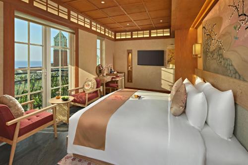 a bedroom with a large bed and a large window at Sakurakyo Hotel & Spa Phu Quoc - Free Hon Thom Island Waterpark Cable Car Until 15 December 2025 in Phu Quoc