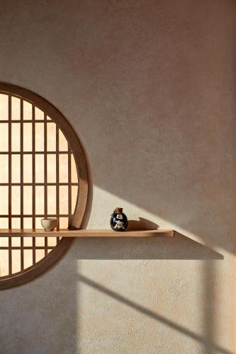 a vase sitting on a shelf in a room at Sakurakyo Hotel & Spa Phu Quoc - Free Hon Thom Island Waterpark Cable Car Until 15 December 2025 in Phu Quoc