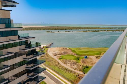 a view of a golf course from a building at Voyage 2 Bedroom In Mayan With Beach Access in Abu Dhabi