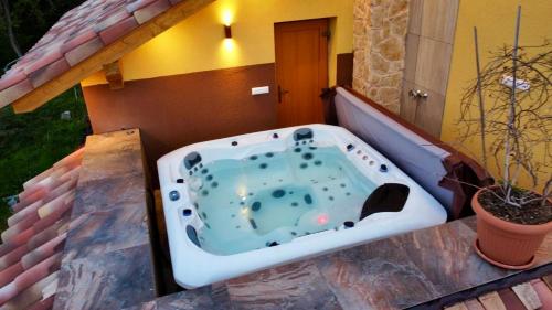 a bath tub sitting on top of a house at Villa Beelvita&Jacuzzi in Bielovce