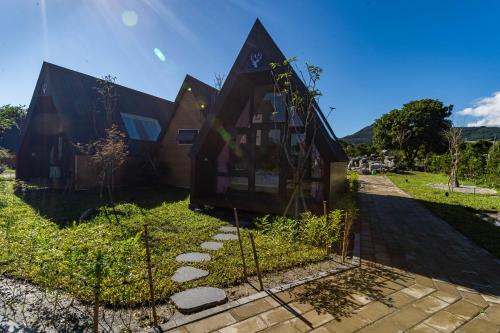 a house with a fence in front of it at 微風星語名宿WindStar B&B in Jian