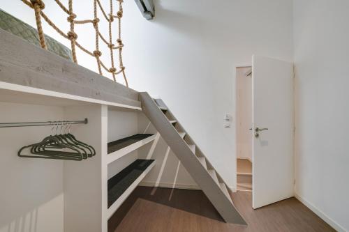 a staircase in a room with white walls at Gite de l'école des Gourmands in Moulin-Neuf