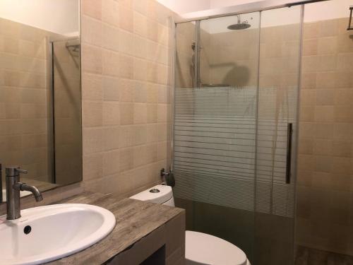 a bathroom with a toilet and a sink and a shower at Capital Wind Beach Cabanas in Kalpitiya