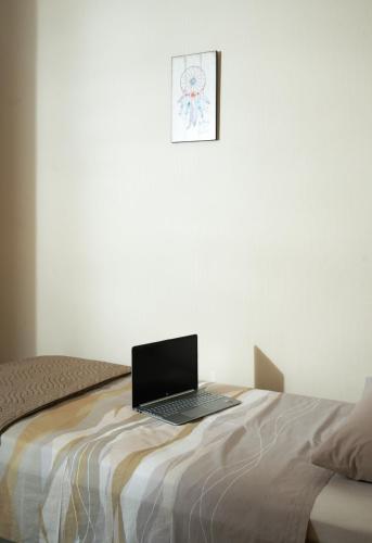 a laptop computer sitting on top of a bed at Silva Luxury House in Mires (South Crete) in Moírai