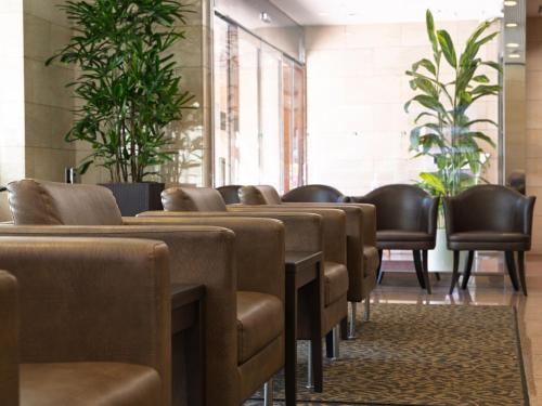 a row of brown chairs in a waiting room at Nishitetsu Inn Tenjin in Fukuoka