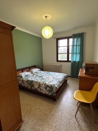 une chambre avec un lit, un bureau et une chaise dans l'établissement Mas de Barthe Avignon, Ile de la Barthelasse, à Avignon