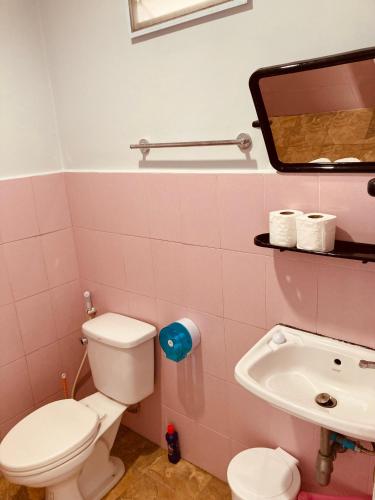 a pink bathroom with a toilet and a sink at Seasalt 1 Cozy Studio with Full kitchen and fast WiFi in Thong Sala