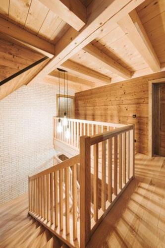 a wooden staircase in a room with wooden ceilings at Mariandl Alm in Reichraming