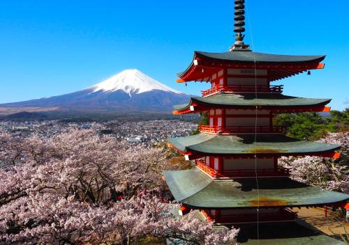 a pagoda with a mountain in the background at Japan Kominka in perfect location for Mount FUJI trip in Fujiyoshida