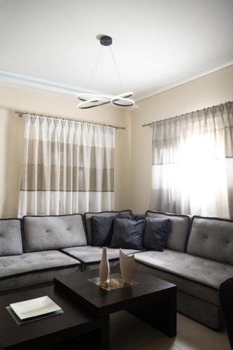a living room with a couch and a table at Silva Luxury House in Mires (South Crete) in Moírai