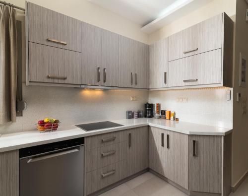 a kitchen with white counter tops and wooden cabinets at Silva Luxury House in Mires (South Crete) in Moírai
