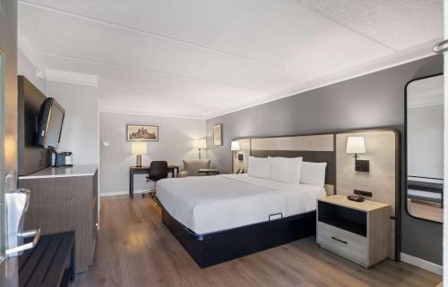 a hotel room with a bed and a television at La Quinta Inn by Wyndham Stockton in Stockton