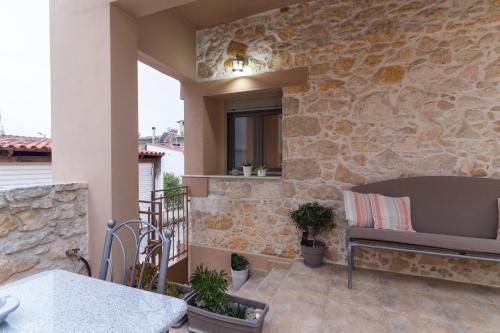 a patio with a bench and a stone wall at Silva Luxury House in Mires (South Crete) in Moírai