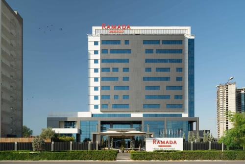 a tall building with a kazania sign on it at Ramada by Wyndham Erbil Gulan Street in Erbil