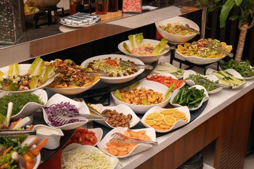 a buffet line with many different types of food at Ramada by Wyndham Erbil Gulan Street in Erbil