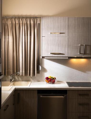 a kitchen with a sink and a bowl of fruit on the counter at Silva Luxury House in Mires (South Crete) in Moírai