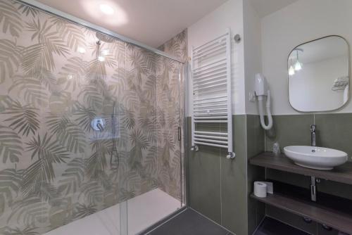 a bathroom with a shower and a sink at Hotel Due Palme in Mergozzo