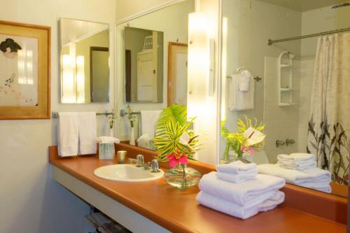 a bathroom with a sink and a mirror at Beachfront Bungalow Walk to Ocean & Restaurants in Lihue