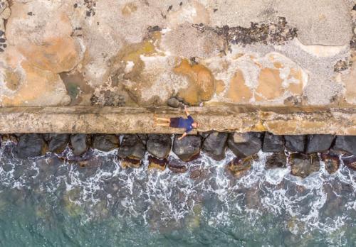 an aerial view of a rock pier with water at Beachfront Bungalow Walk to Ocean & Restaurants in Lihue