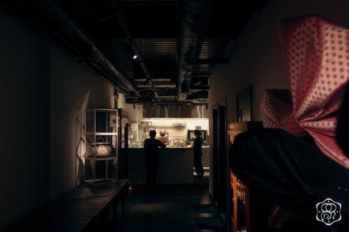 a man standing at a counter in a kitchen at Amanaki Saigon Boutique Hotel in Ho Chi Minh City