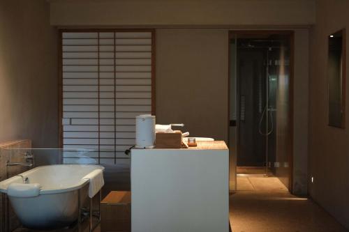 a bathroom with a tub and a sink and a bath tub at Rakuhotel in Wenzhou