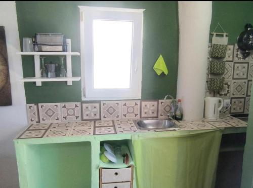 a toy kitchen with a sink and a window at Beachfront Studio with Private Kitchen and Bath in Algeciras
