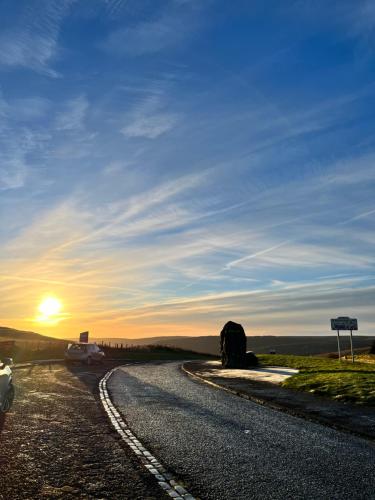 a road with cars on it with the sun setting at TheFlatInJed in Jedburgh