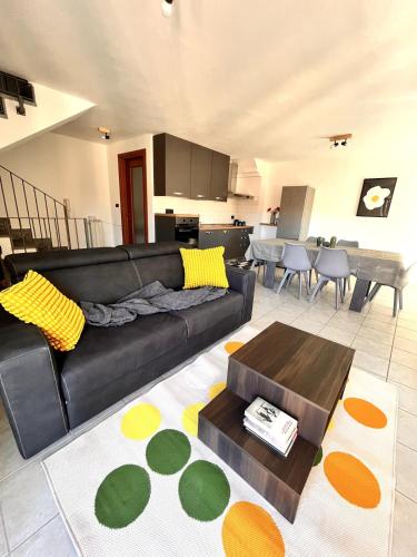 a living room with a black couch and a table at La quiete in centro in Chivasso