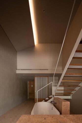 a bathroom with a bath tub and a staircase at Rakuhotel in Wenzhou