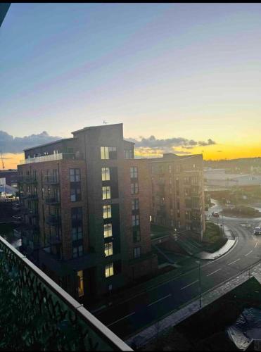 a view of a building with the sunset in the background at Charming Dartford Apartment with 1 Bedroom in Dartford