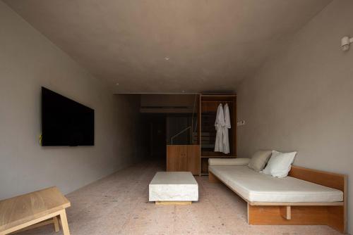 a living room with a couch and a flat screen tv at Rakuhotel in Wenzhou
