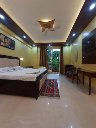 a large bedroom with a bed and a piano at Aloha Rishikesh India Apartment by Nibhachi in Rishīkesh