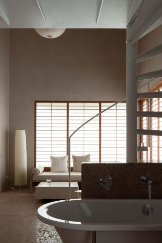 a living room with a couch and a large window at Rakuhotel in Wenzhou