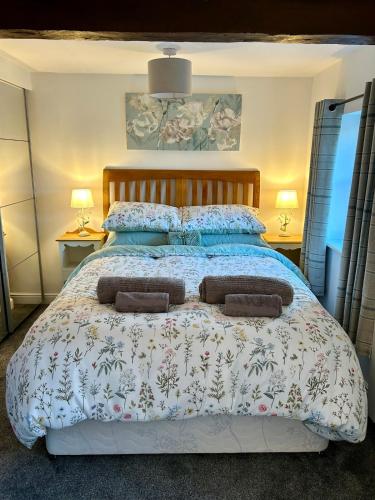 a bedroom with a large bed with two pillows at 1 Bed cottage town centre free private parking cycle store Boroughbridge in Boroughbridge